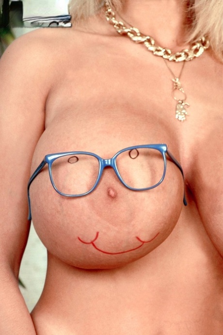 Mature MILF Tiffany Towers takes off her glasses before uncupping giant boobs