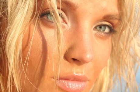 Hot blonde Ines Cudna sets her great tits free of bikini as the tide comes in