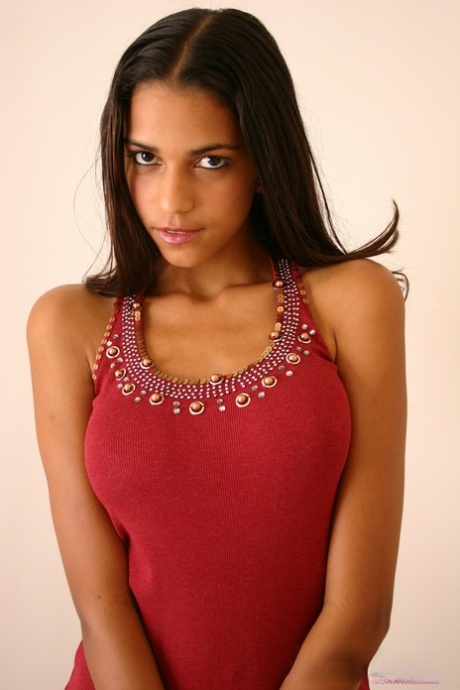 Alluring Latina girl Polliana cups her large tits in tight blue jeans