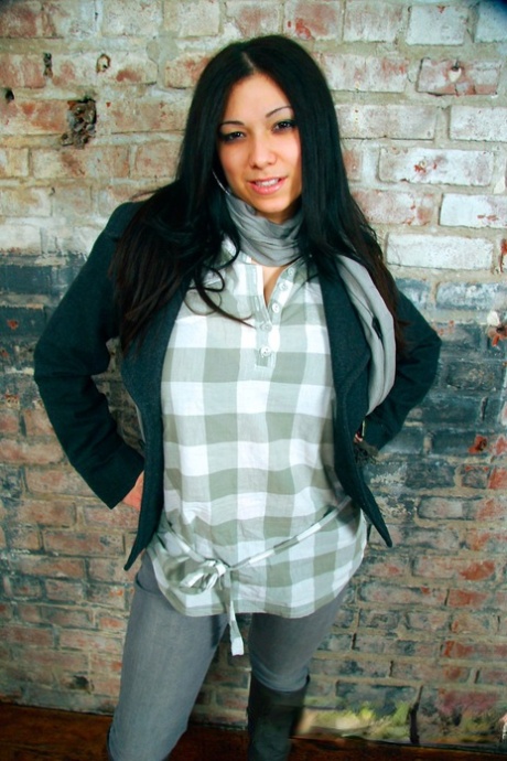 Dark-haired girl Elizabeth places her hands over her large breasts