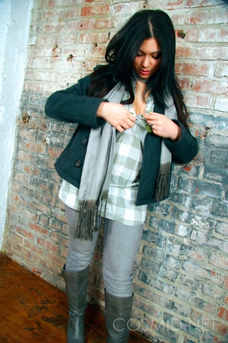 Dark-haired girl Elizabeth places her hands over her large breasts