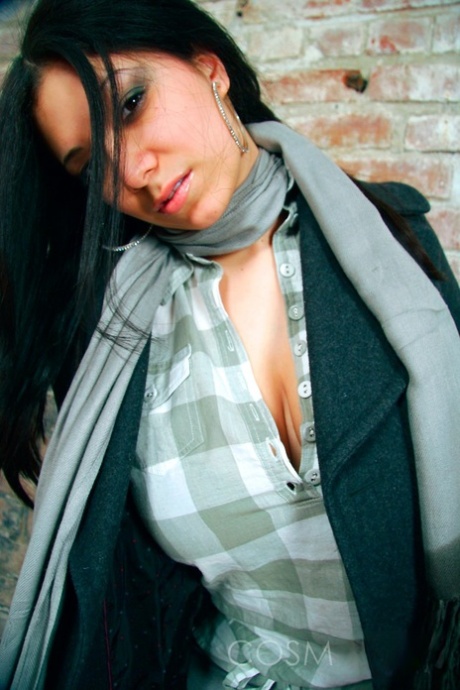 Dark-haired girl Elizabeth places her hands over her large breasts