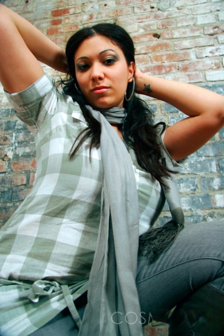 Dark-haired girl Elizabeth places her hands over her large breasts