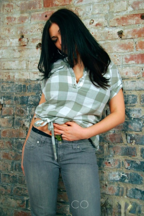 Dark-haired girl Elizabeth places her hands over her large breasts