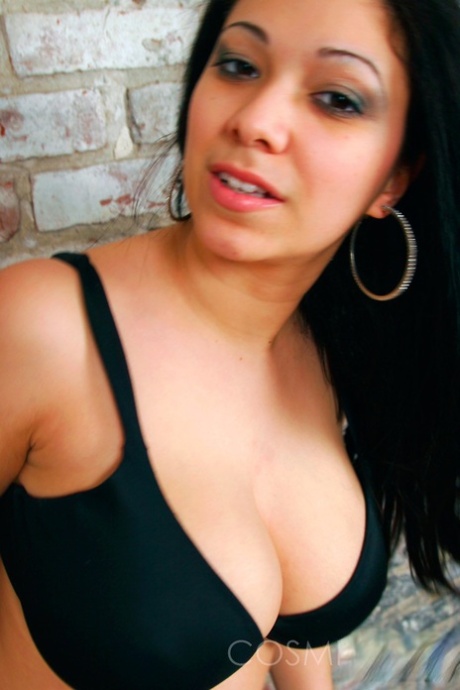Dark-haired girl Elizabeth places her hands over her large breasts