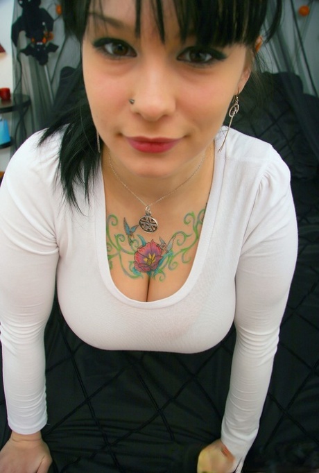 Gorgeous tattooed Jennique slides her huge breasts out of her tight sweater
