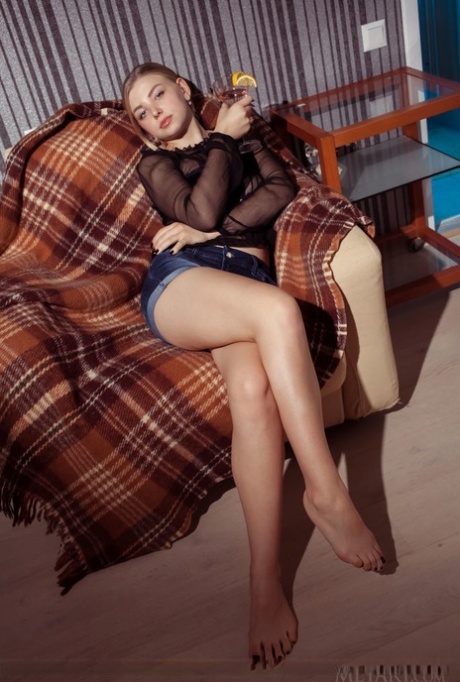 Cute young blonde Daniel Sea chills with a cocktail while spread naked