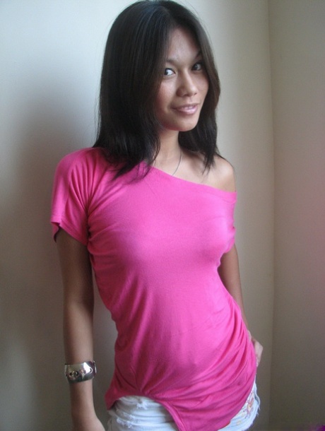 Perky titted girl removes her short skirt to open her legs wide & pose naked