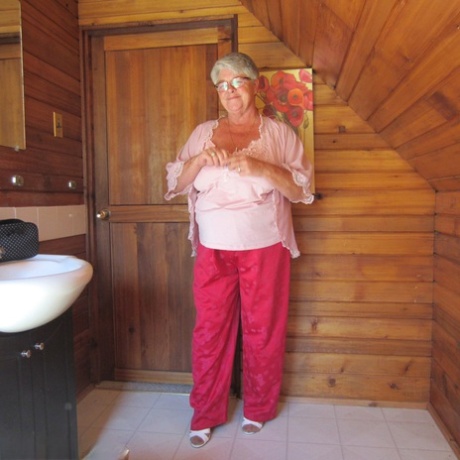 Naughty nan with short grey hair bares her big tits and butt with a striptease