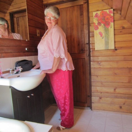Naughty nan with short grey hair bares her big tits and butt with a striptease