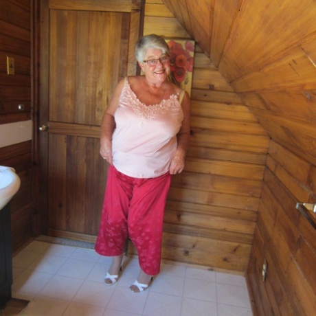 Naughty nan with short grey hair bares her big tits and butt with a striptease