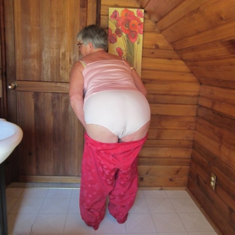 Naughty nan with short grey hair bares her big tits and butt with a striptease
