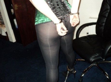 Chubby redhead sports a cleave gag with her wrists handcuffed behind her back