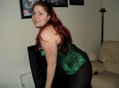 Chubby redhead sports a cleave gag with her wrists handcuffed behind her back