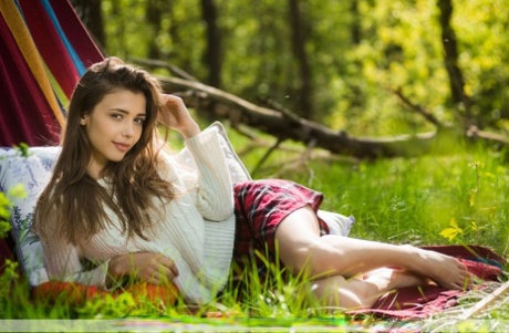 Sweet teen Milla D gets totally naked while outdoors on a hammock