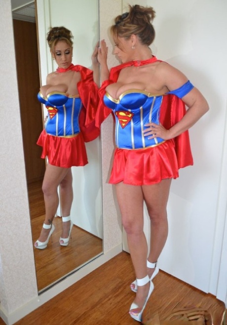 Sexy MILF Eva Notty sports cum on her tits while removing a Superman costume