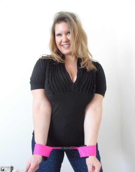 Thick amateur woman Busty Kris Ann shows her enhanced tits while cuffed