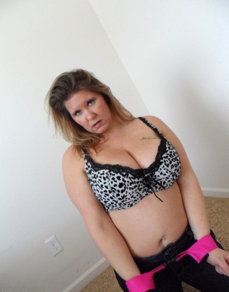 Thick amateur woman Busty Kris Ann shows her enhanced tits while cuffed