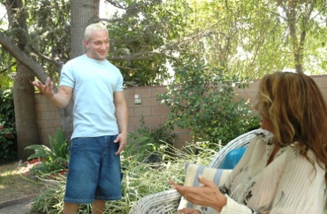 Big titted cougar Lisa Lipps has sex with a young man in her backyard garden