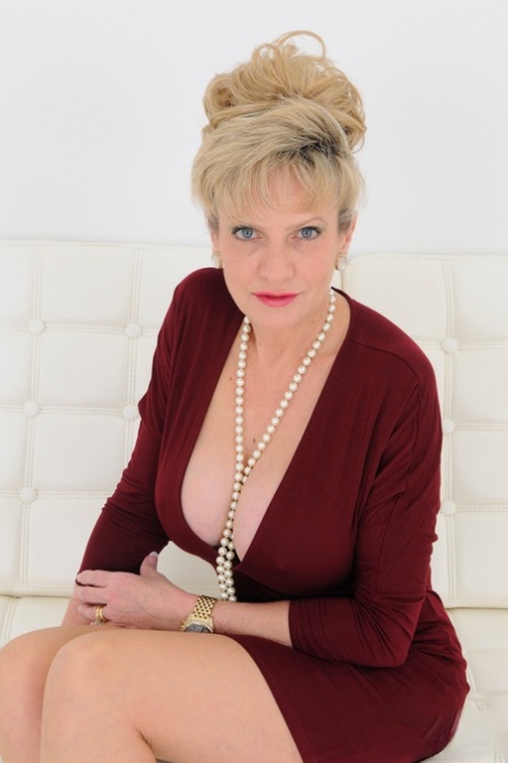 Mature UK blonde Lady Sonia pinches her nipples while showing her juggs