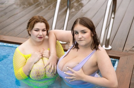 Fat lesbians Mary Brown & Molly Evans play with each others giant boobs