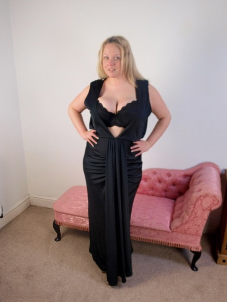 Plump blonde Sindy Bust gets naked on a chaise lounge in her stockings