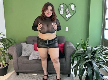 Overweight redhead Megan Ruiz squeezes her big boobs after getting naked
