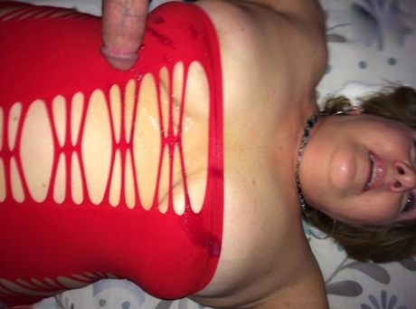 Mature woman Busty Bliss licks a penis while showing her big boobs