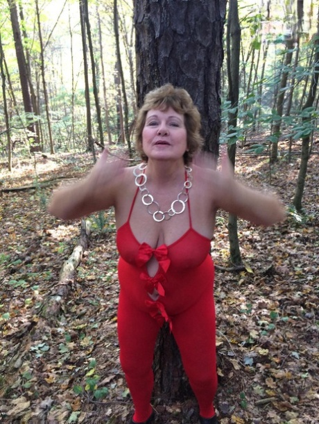 Older lady Busty Bliss gets completely naked while in a forest