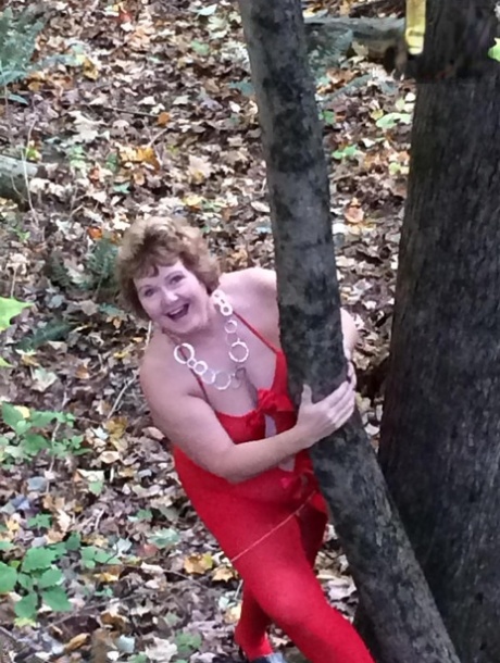 Older lady Busty Bliss gets completely naked while in a forest