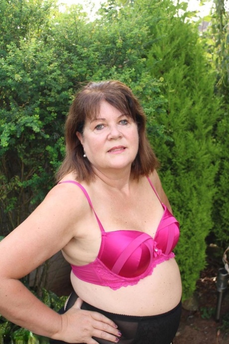 Mature woman Cassandra Uk slides her underwear aside to get at her horny pussy