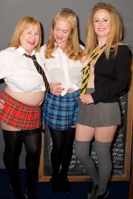 Older and younger lesbian teachers show their natural tits in a classroom