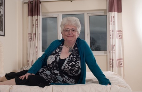 Overweight British grandmother covers her naked boobs with her hands
