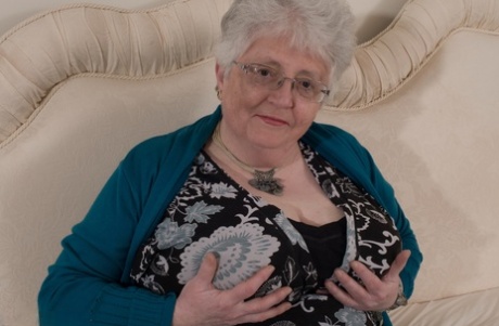 Overweight British grandmother covers her naked boobs with her hands