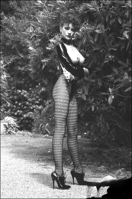 Leggy lady in fetish outfit exposing her boobs in vintage photo set