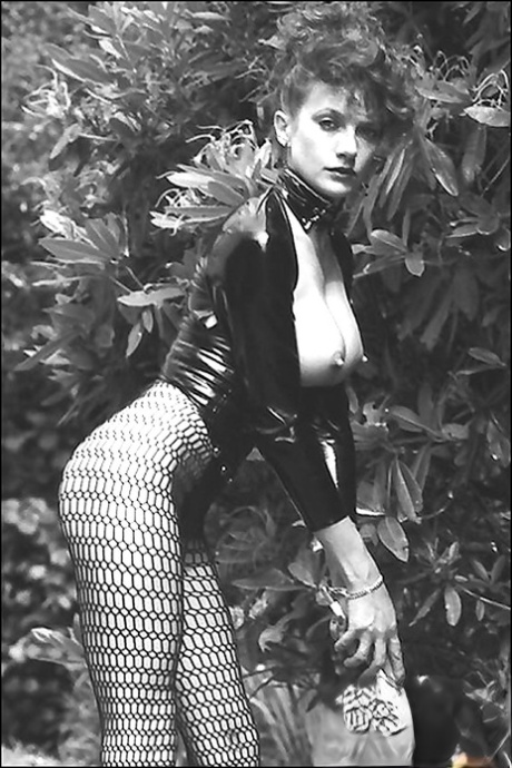 Leggy lady in fetish outfit exposing her boobs in vintage photo set