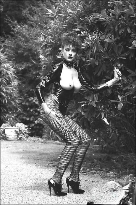 Leggy lady in fetish outfit exposing her boobs in vintage photo set