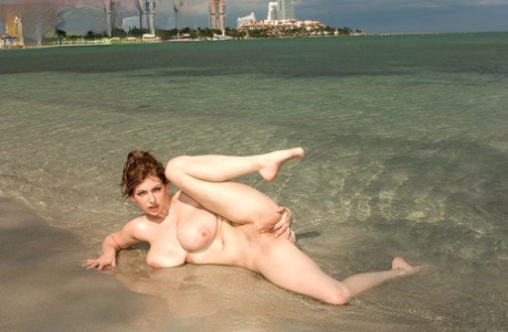 Christy Marks removes her bikini to flaunt hooters and twat on public beach