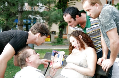 Curly-haired pregnant slut gets banged by four horny lads outdoor