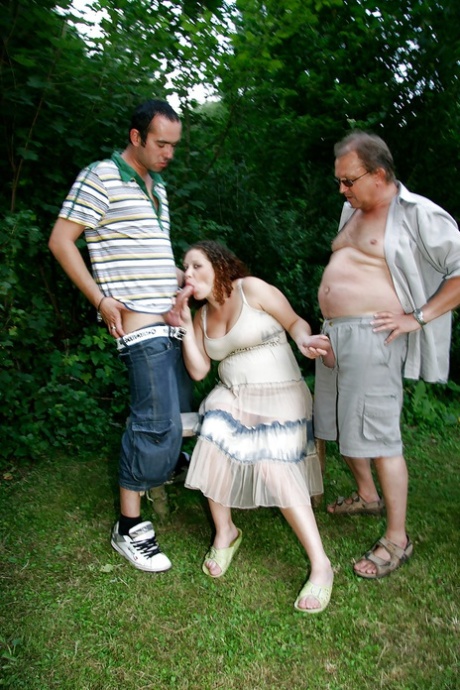 Curly-haired pregnant slut gets banged by four horny lads outdoor