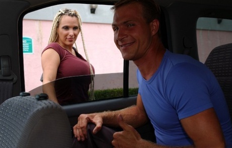 Slutty MILF with boobacious tatas goes down on a stiff cock in the car