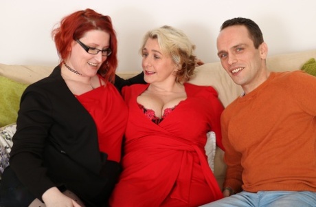 Big boobed ladies Camilla C & Rue Bourbon give a cute stud a double blowjob