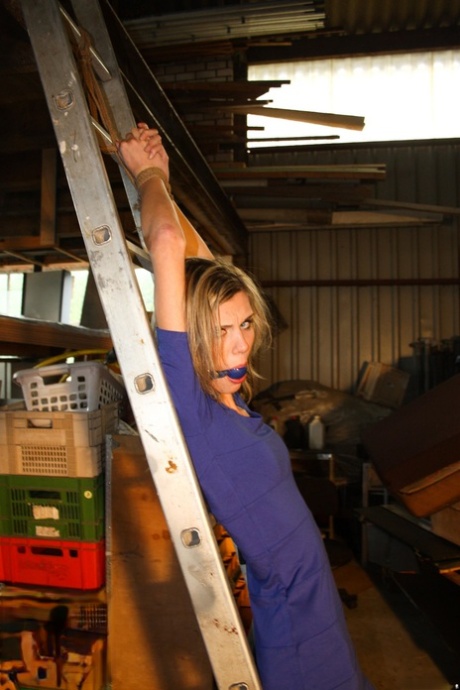 Amateur blonde Irena gagged & tied fully clothed to a ladder for garage grope