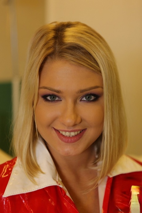 Blonde babe in nurse uniform Lucy Heart flashes with her natural boobies