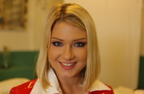 Blonde babe in nurse uniform Lucy Heart flashes with her natural boobies
