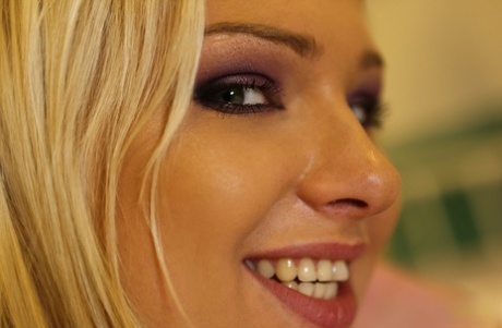 Blonde babe in nurse uniform Lucy Heart flashes with her natural boobies
