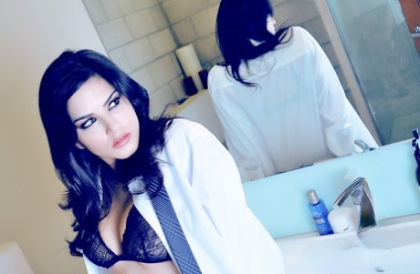 Dark-haired pornstar Sunny Leone removes her bra & shows her big juggs
