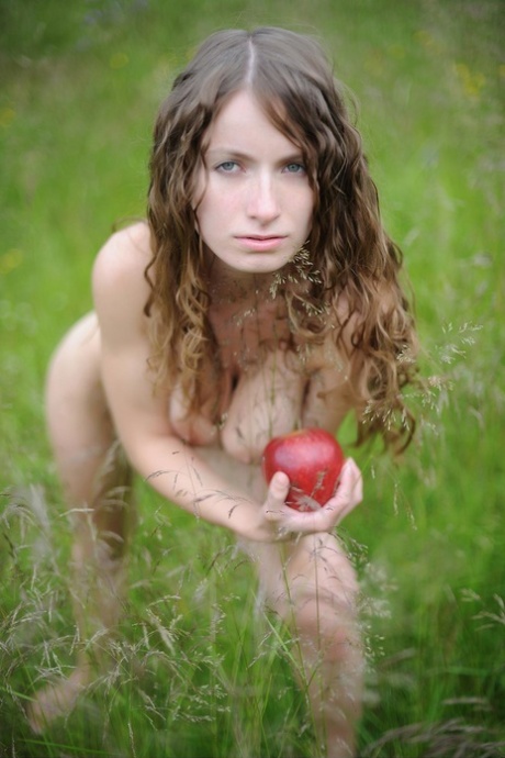 Sweet petite babe Ekitti lets out her big tits and poses outdoors in a solo