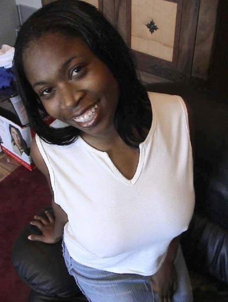Ebony cutie Carla unveiling her huge natural breasts and round booty