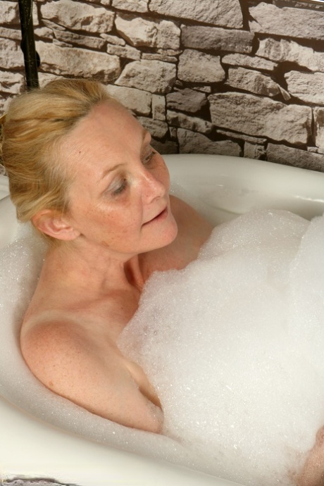 Smiley British woman Suzie Stone washes her big tits and mature pussy